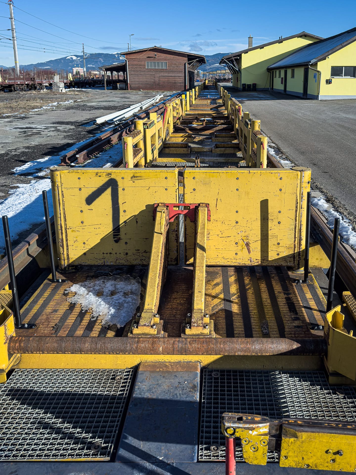 Rail loading platform and industrial equipment at an active site in Zeltweg, Austria.