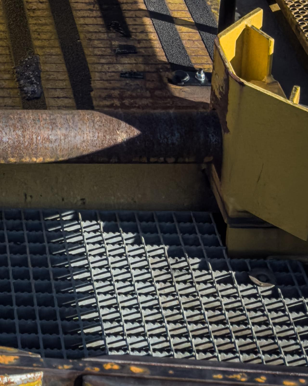 Close-up of worn industrial machinery and metal grating in Zeltweg.