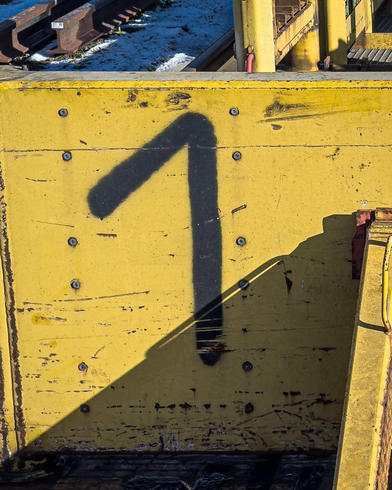 Yellow industrial barrier marked with a black directional number, one.